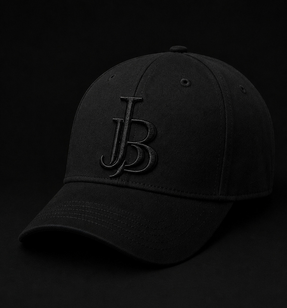 JUST B Drop 01 — deep black cap with tonal JB monogram embroidery